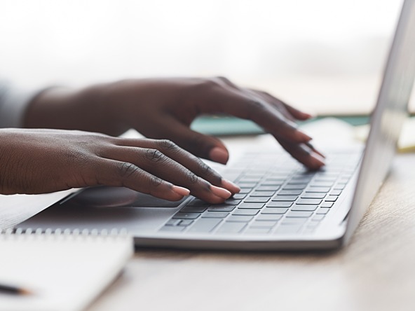 Black person using keyboard laptop office working work_crop